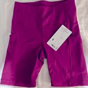 Brand new Athleta shorts. Ultimate stash pocket (7 inch). Mulberry pink. XS.